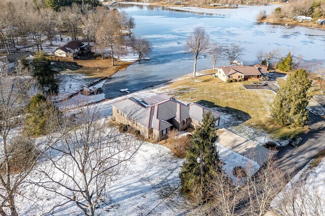 snowy aerial view with a water view