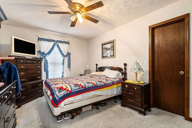 bedroom with light carpet, a ceiling fan, and a textured ceiling