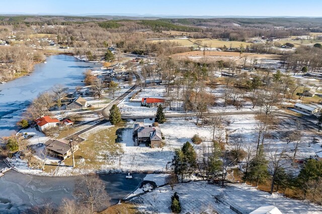 snowy aerial view featuring a water view