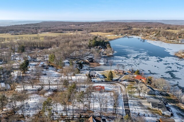 snowy aerial view featuring a water view