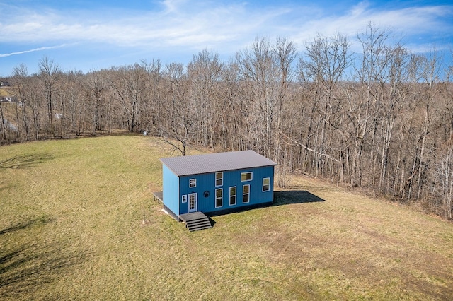 birds eye view of property with a forest view