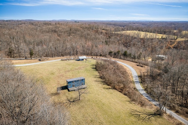 birds eye view of property featuring a rural view and a forest view