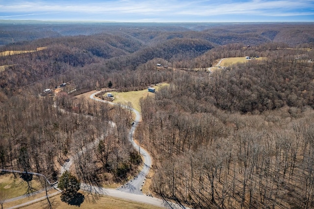 birds eye view of property featuring a wooded view