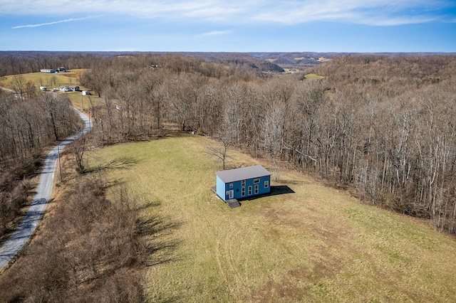 aerial view featuring a view of trees and a rural view