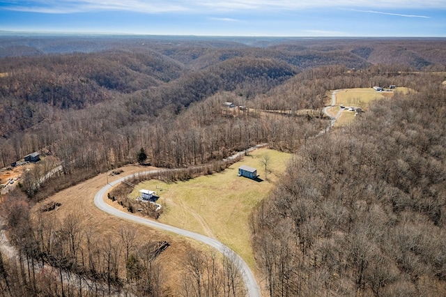 birds eye view of property with a rural view and a wooded view