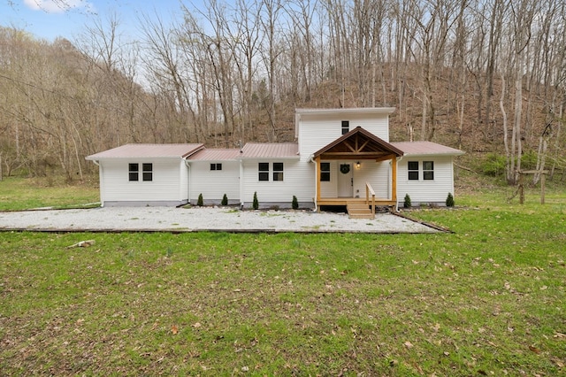 1069 Pleasant Shade Hwy, Pleasant Shade, TN 37145 - view of front of property featuring a front yard, a metal roof, and a view of trees