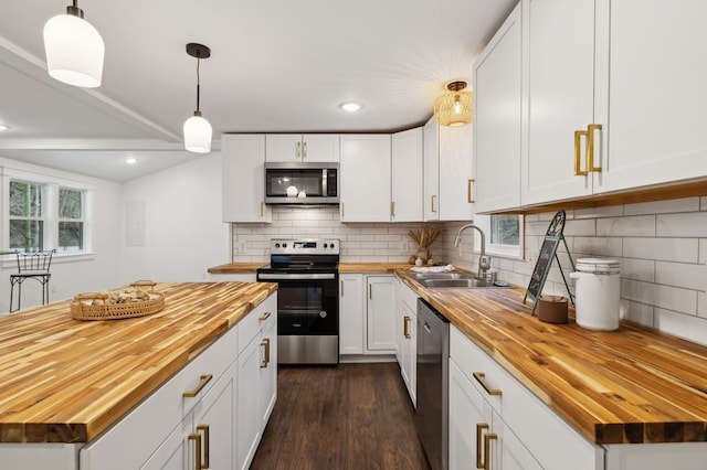 1069 Pleasant Shade Hwy, Pleasant Shade, TN 37145 - kitchen with butcher block countertops, appliances with stainless steel finishes, dark wood-style floors, white cabinets, and decorative backsplash