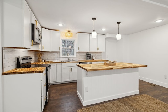1069 Pleasant Shade Hwy, Pleasant Shade, TN 37145 - kitchen with wood counters, appliances with stainless steel finishes, white cabinets, backsplash, and recessed lighting