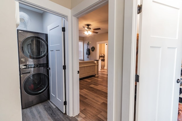 clothes washing area with laundry area, wood finished floors, ceiling fan, and stacked washer and dryer