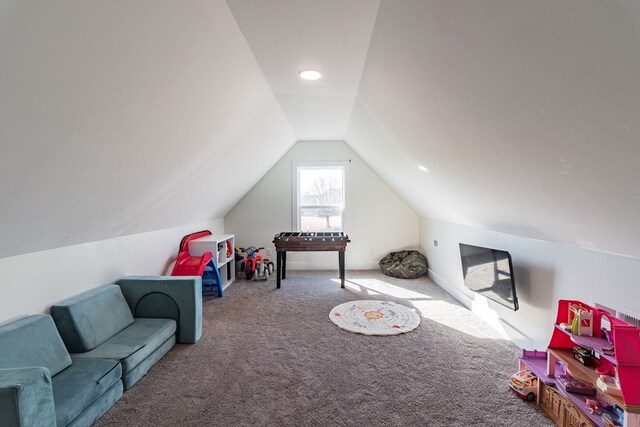 playroom with carpet and vaulted ceiling