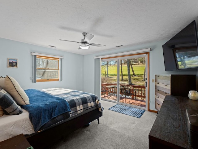 bedroom with visible vents, ceiling fan, access to outside, a textured ceiling, and carpet floors