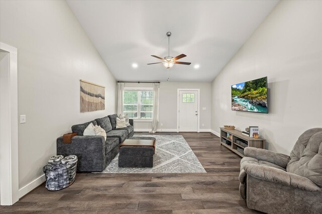 living area with dark wood-style floors, ceiling fan, baseboards, and high vaulted ceiling