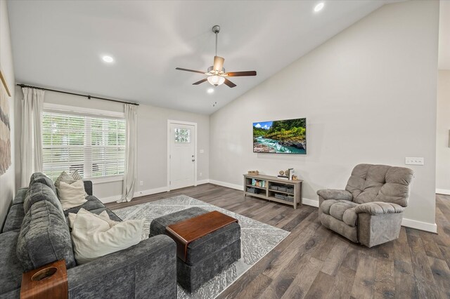 living room with high vaulted ceiling, dark wood finished floors, a ceiling fan, and baseboards