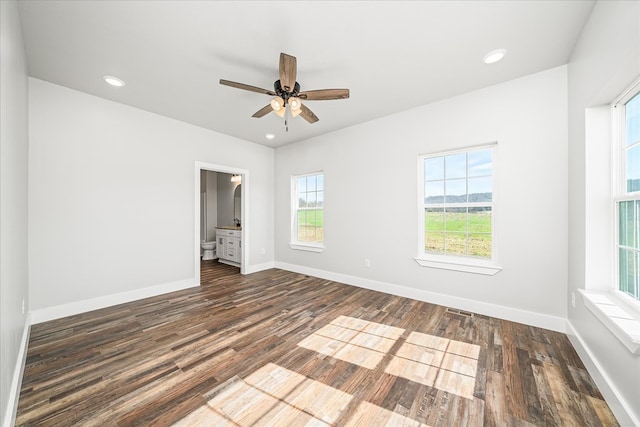 unfurnished room with baseboards, dark wood-type flooring, and recessed lighting