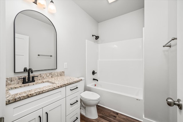 full bathroom with toilet, shower / bathing tub combination, wood finished floors, and vanity