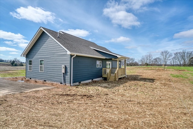 view of property exterior with crawl space and roof with shingles