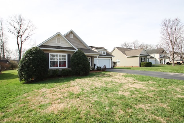 view of front of house with driveway, a front lawn, and a garage
