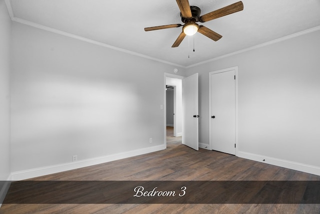 empty room with dark wood-style floors, ceiling fan, baseboards, and ornamental molding