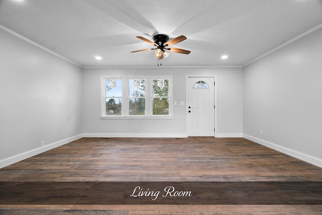 foyer entrance with dark wood-type flooring, ornamental molding, a textured ceiling, and baseboards