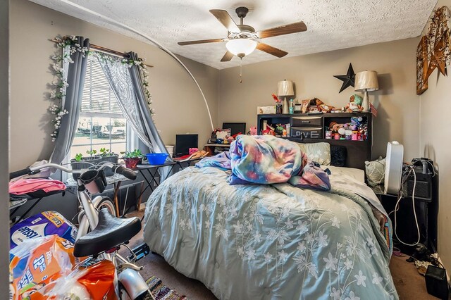 bedroom with ceiling fan and a textured ceiling