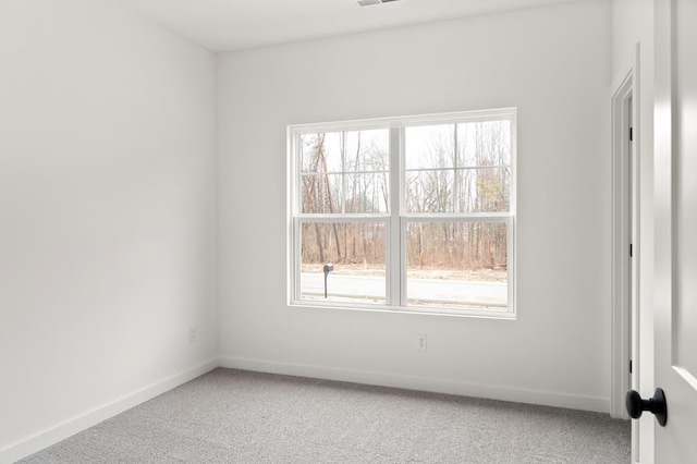 unfurnished room with visible vents, baseboards, and light colored carpet