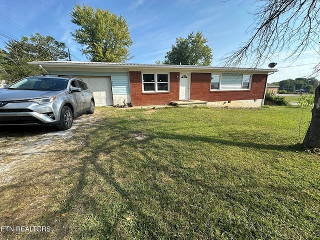 ranch-style home featuring a garage, brick siding, driveway, and a front lawn