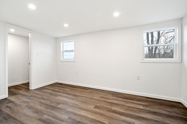 interior space featuring baseboards, dark wood finished floors, and recessed lighting