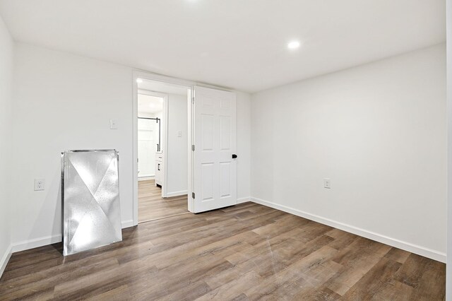 unfurnished room with baseboards and wood finished floors