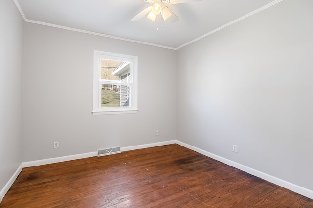 spare room with visible vents, baseboards, and wood-type flooring