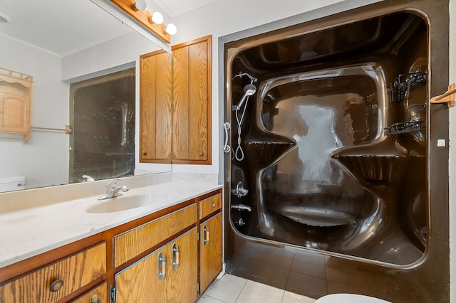 full bathroom featuring tile patterned floors, toilet, ornamental molding, walk in shower, and vanity