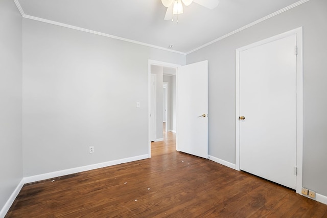 unfurnished bedroom featuring ceiling fan, baseboards, wood finished floors, and crown molding