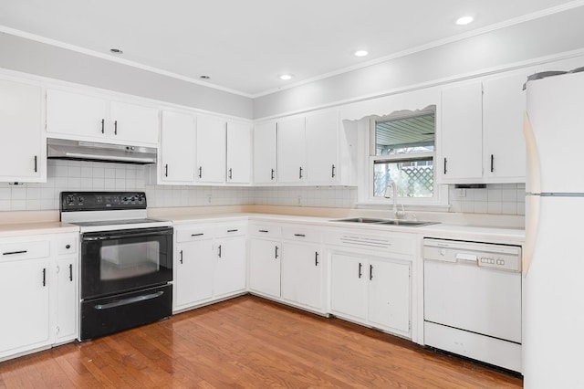 kitchen featuring light wood-type flooring, under cabinet range hood, a sink, white appliances, and white cabinets