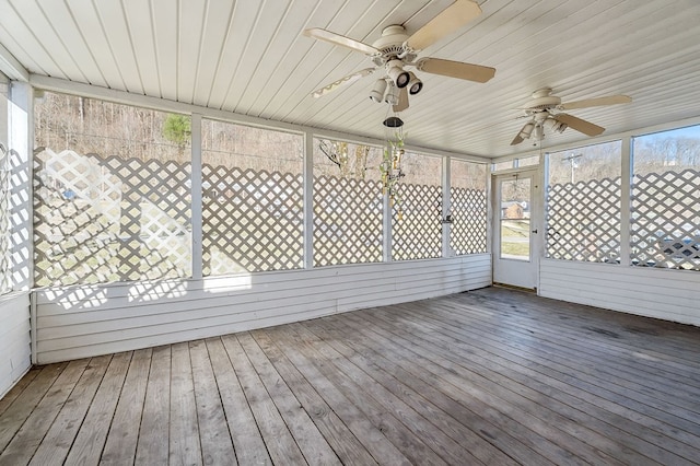 unfurnished sunroom with ceiling fan