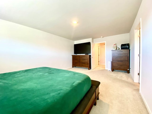 bedroom with baseboards and light colored carpet