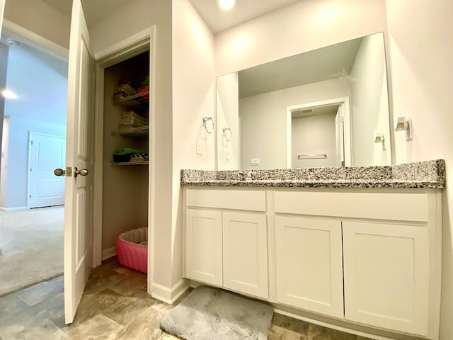 bathroom with baseboards and vanity