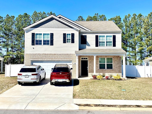 view of front of house featuring driveway, a garage, fence, and brick siding