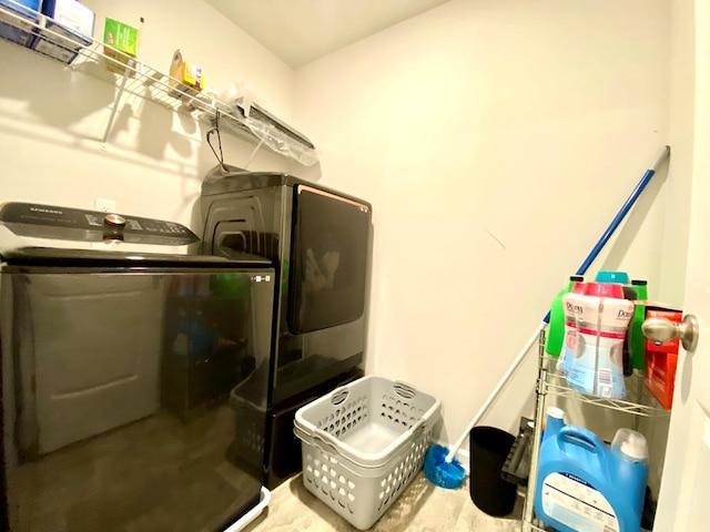 clothes washing area featuring laundry area and washing machine and dryer