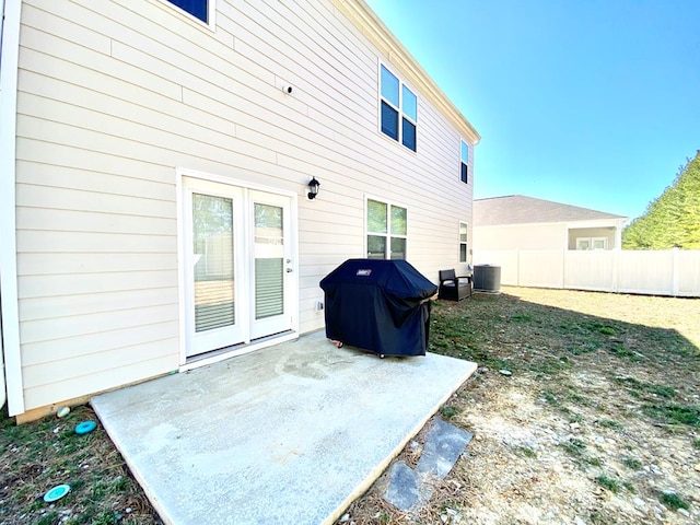 exterior space with a patio, cooling unit, and fence