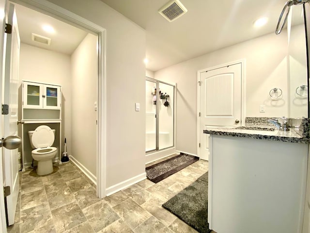 full bathroom with visible vents, toilet, a stall shower, vanity, and baseboards