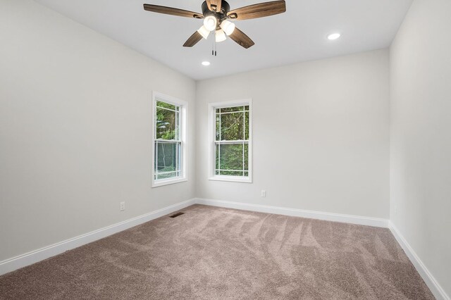 carpeted spare room featuring recessed lighting, visible vents, ceiling fan, and baseboards