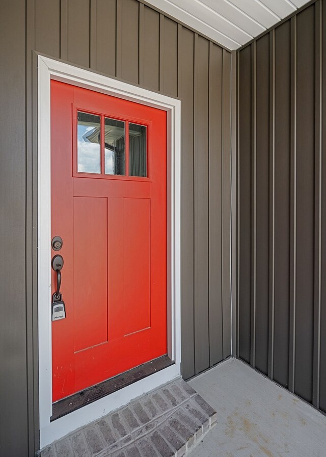 view of exterior entry featuring board and batten siding