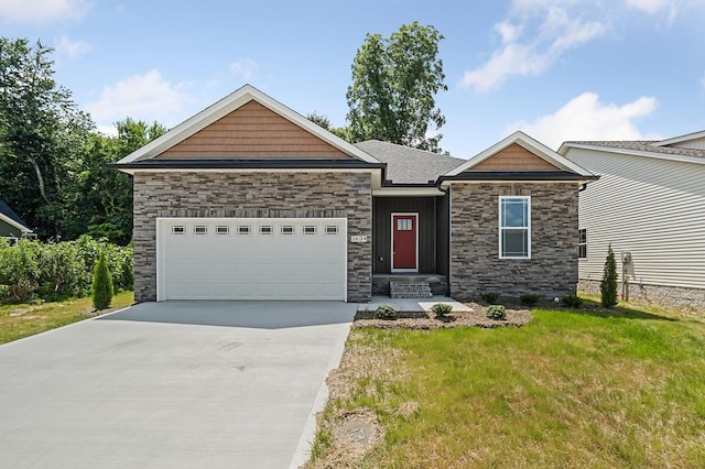 craftsman-style home with a front yard, concrete driveway, and an attached garage