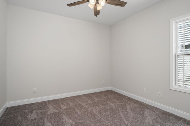 empty room featuring a ceiling fan, carpet flooring, plenty of natural light, and baseboards