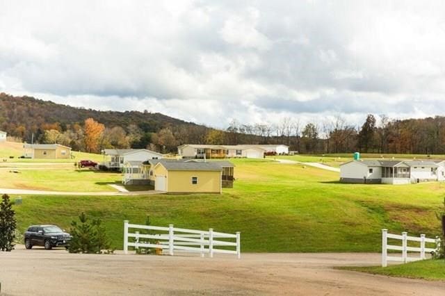 view of community featuring fence and a mountain view