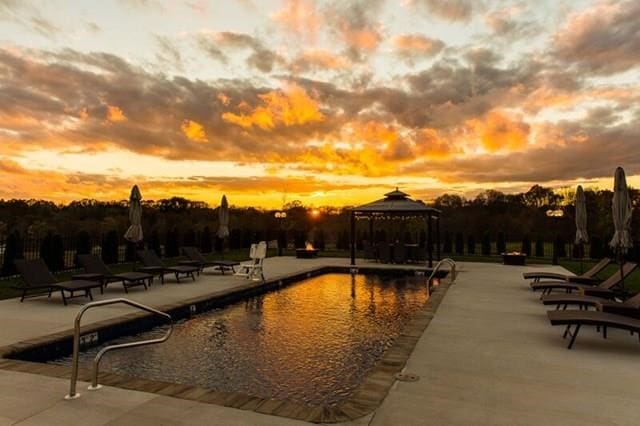 pool with a gazebo and a patio