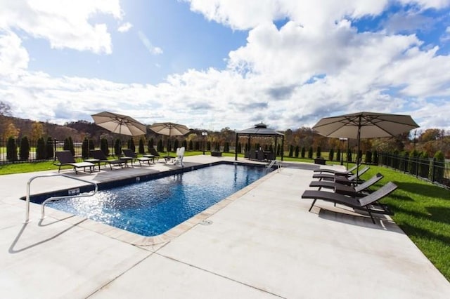 pool featuring a lawn, fence, a patio, and a gazebo