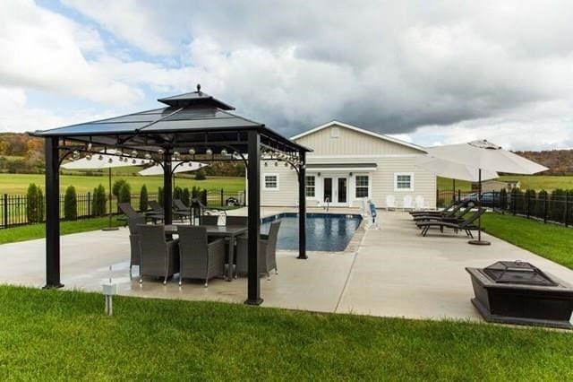 view of pool with a fenced in pool, a patio, a gazebo, an outdoor fire pit, and fence