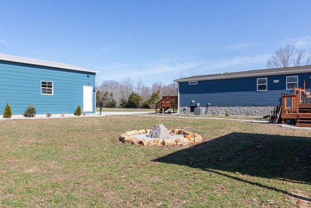 view of yard featuring cooling unit and a wooden deck