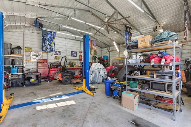 garage featuring a workshop area and metal wall