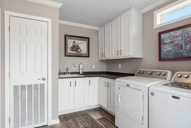 laundry area with cabinet space, dark wood-style flooring, a sink, crown molding, and washing machine and dryer